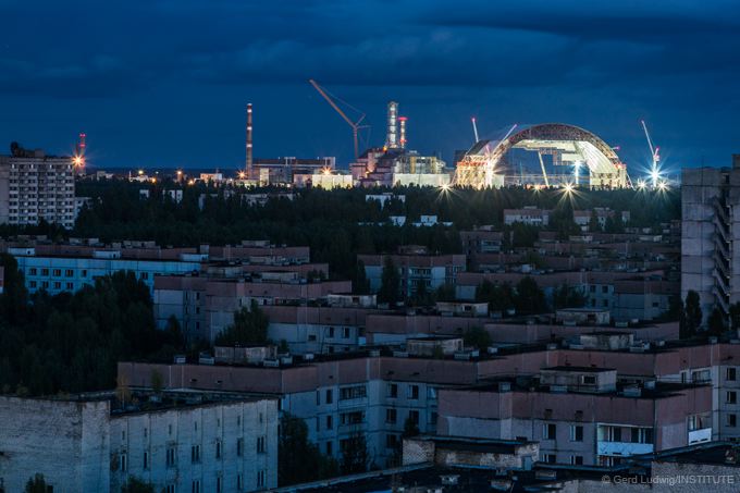 First section of the New Safe Confinement seen from the rooftops of nearby city of Pripyat